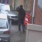 Another image of one of the suspects as he drops a brochure into a dumpster