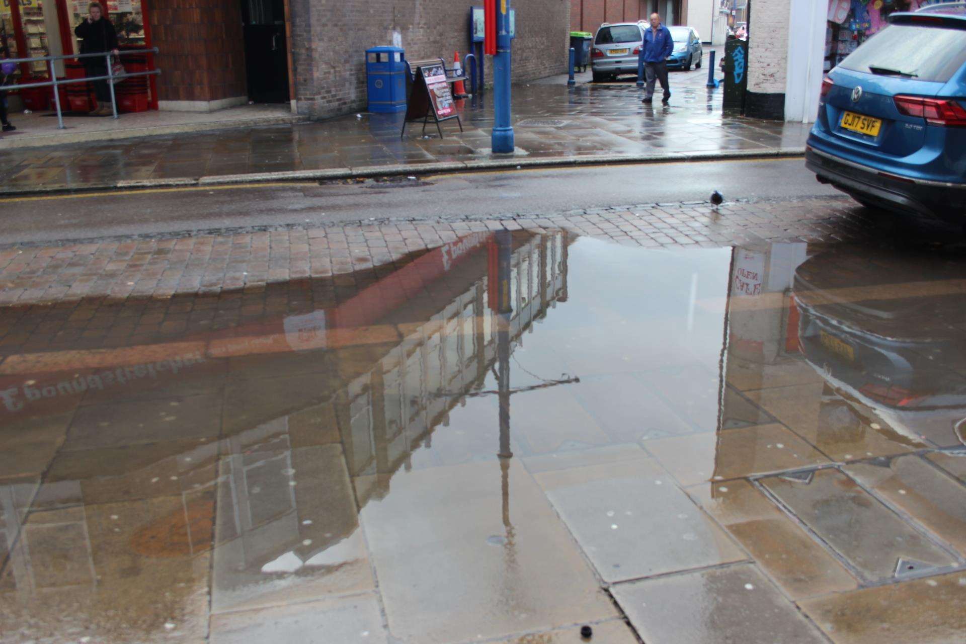 Two blocked drains are in the middle of this puddle in Sheerness High Street (5960021)