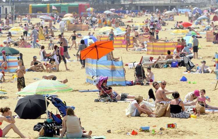 People enjoying the sun on Margate beach. Stock image