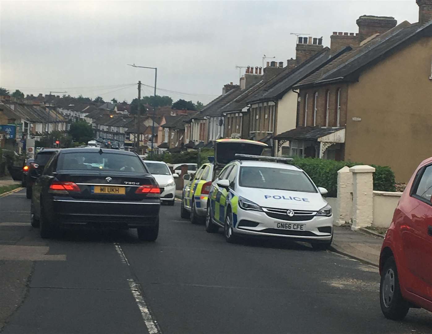 Police cars parked along Singlewell Road before 'raiding' the property on Old Road East