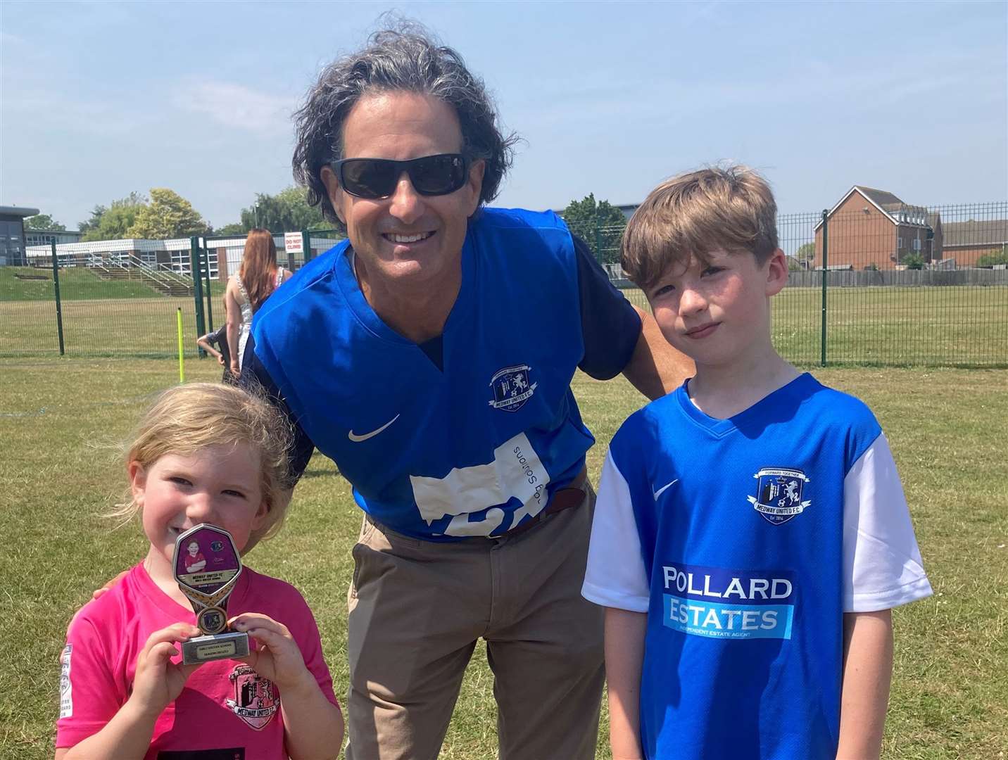 Gillingham owner Brad Galinson with two of the children from Medway United