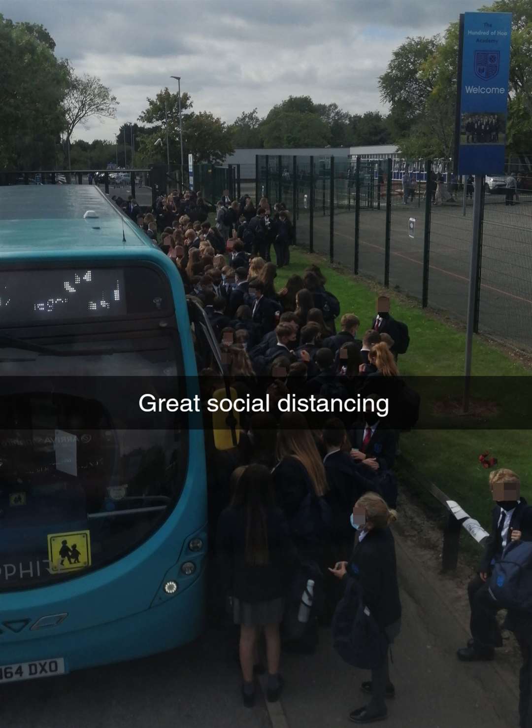 A picture circulated on social media of pupils crowded around the buses outside Hundred of Hoo Academy