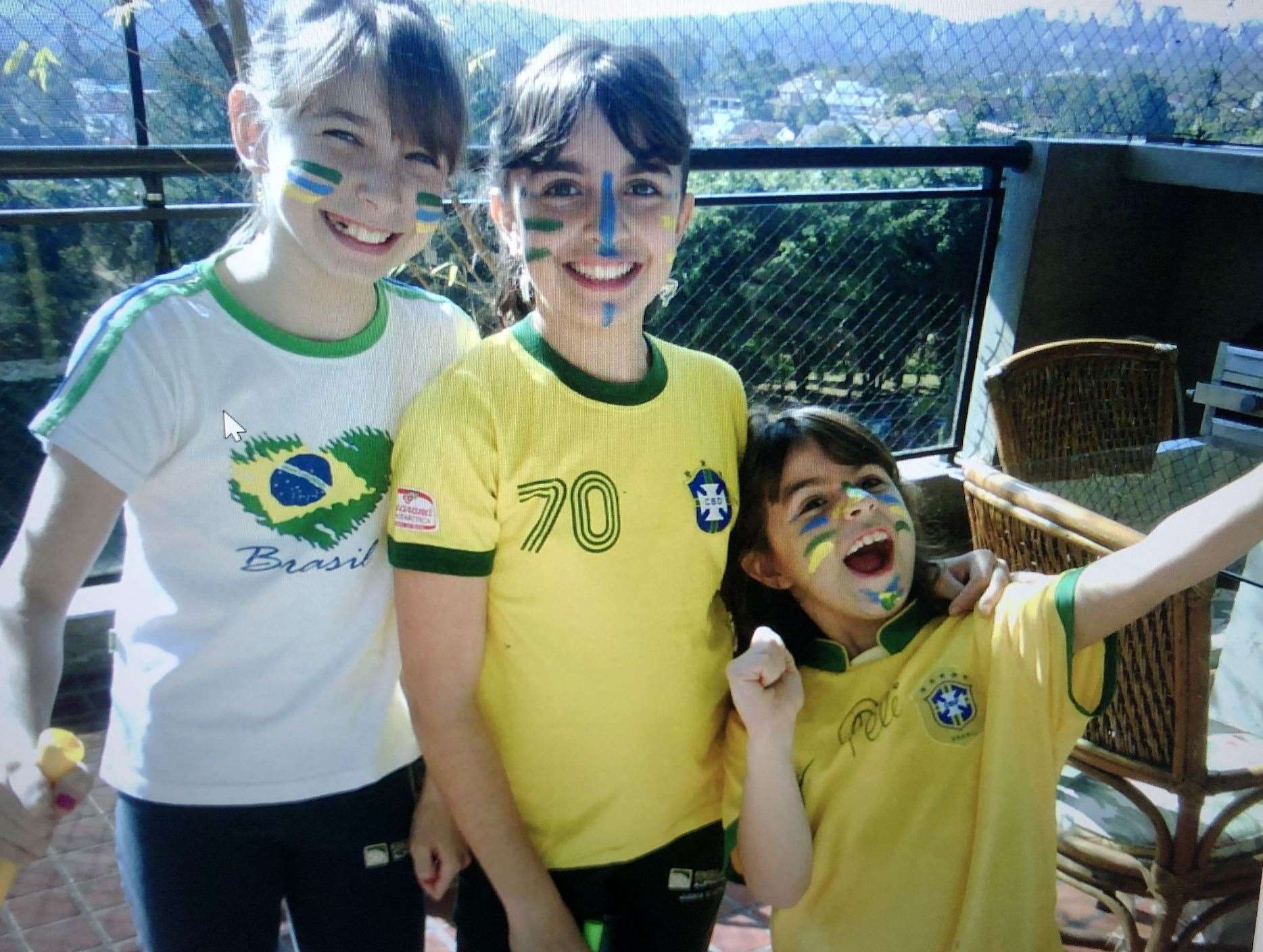 Young July (centre) with her younger sister Gabriela (right) and her school friend Jessica (left) ready to watch the 2010 World Cup