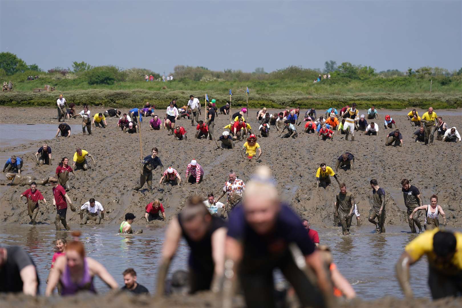 Competitors take part in the annual Maldon Mud Race in May (PA)