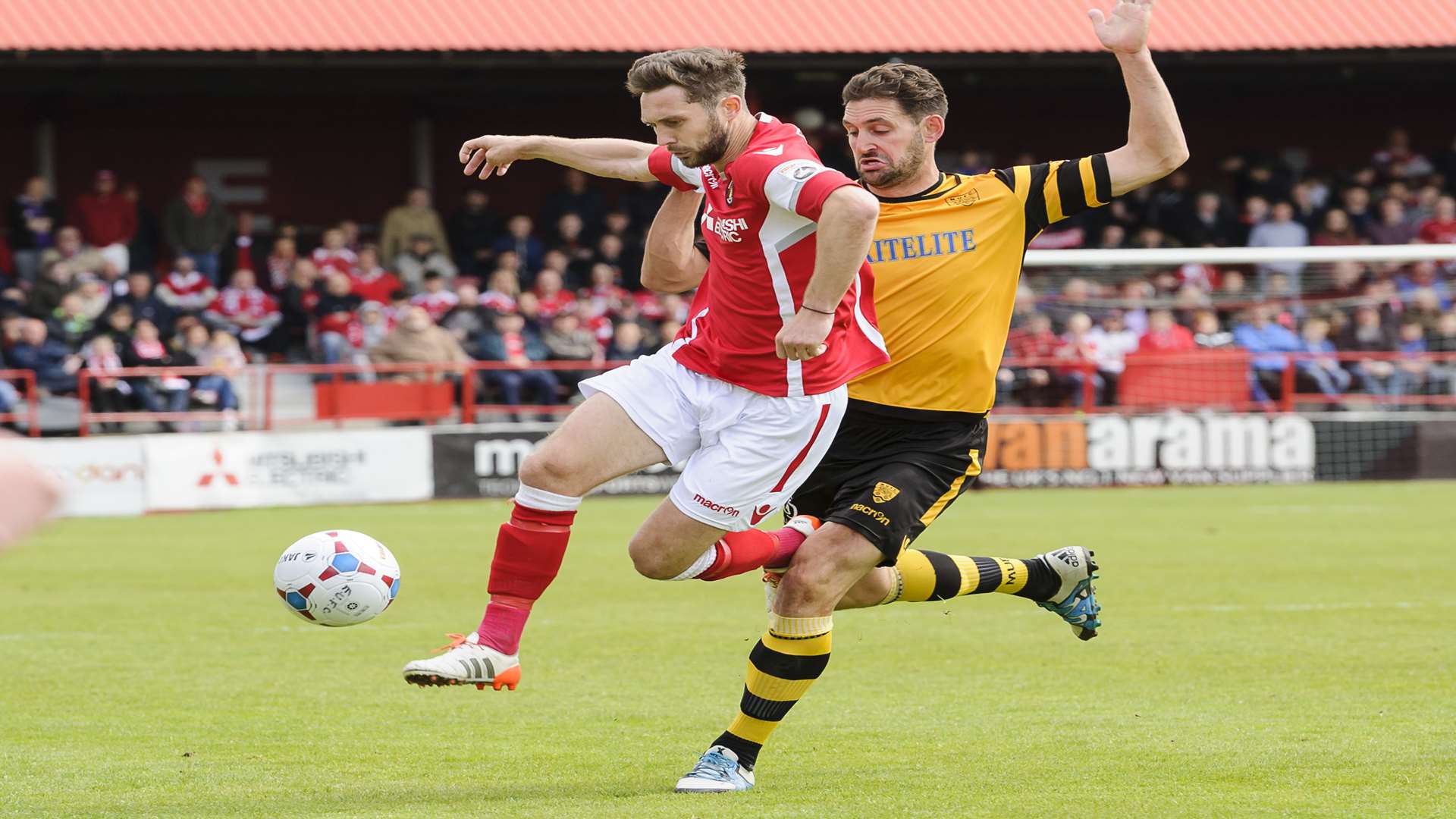 Dean Rance shields the ball from Jay May during the play-off final Picture: Andy Payton