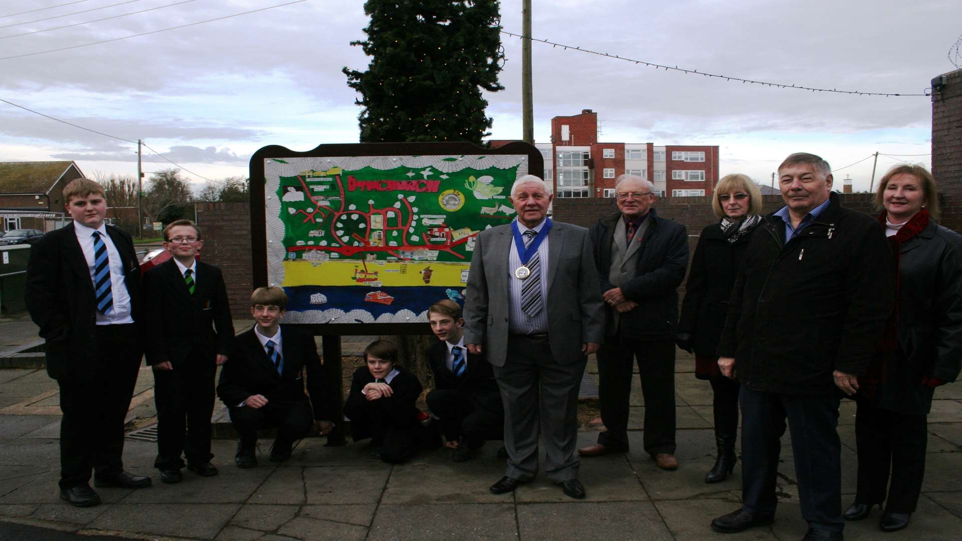 Councillors and Marsh Academy pupils at the unveiling of the Christmas tree and sign.