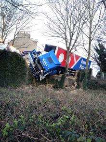 The Domino's Pizza lorry after crashing through the wall.