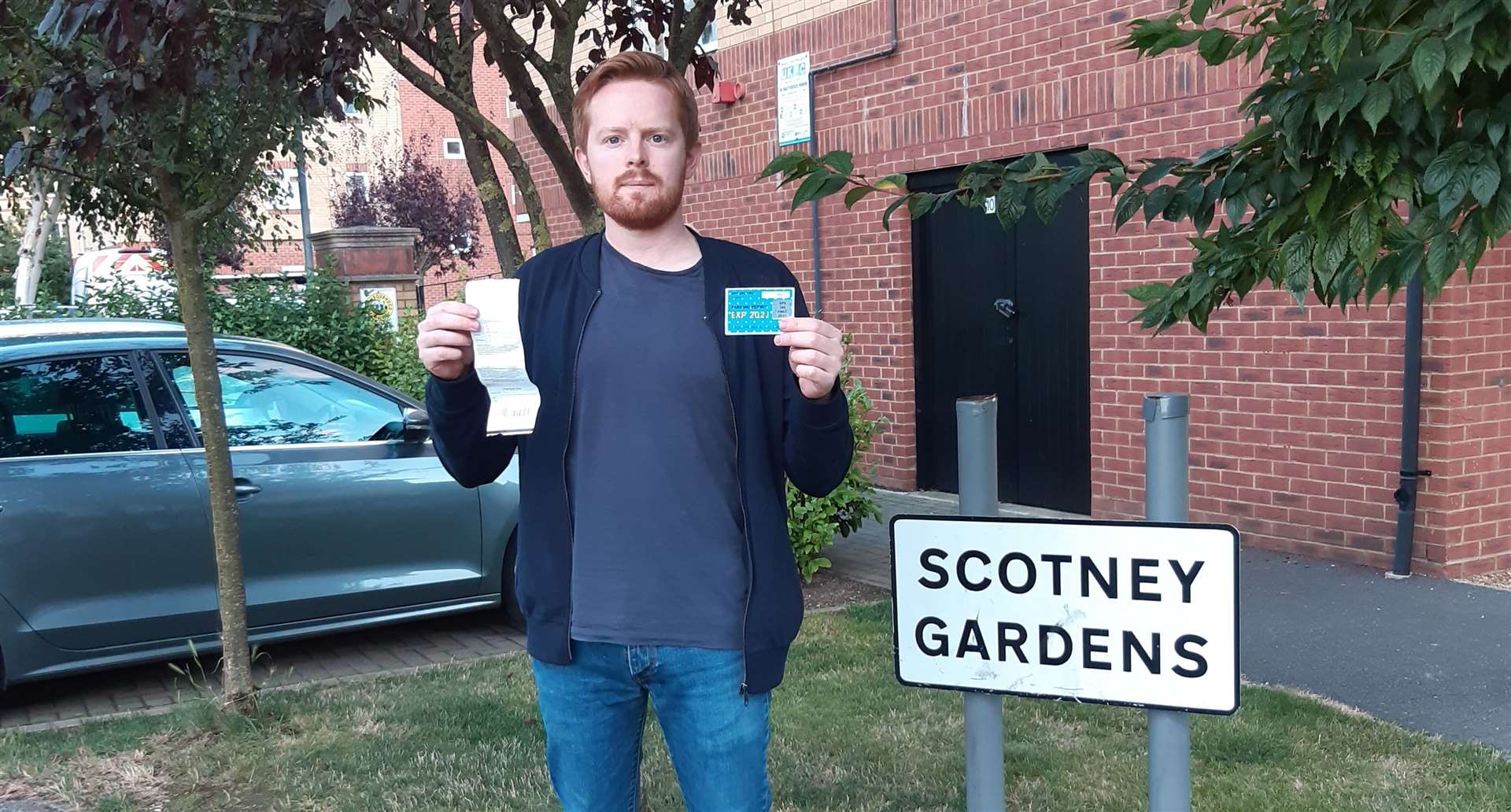 Mr Lawrence Puckett, 31, holding his valid permit and the £100 parking fine. Picture: Lawrence Puckett