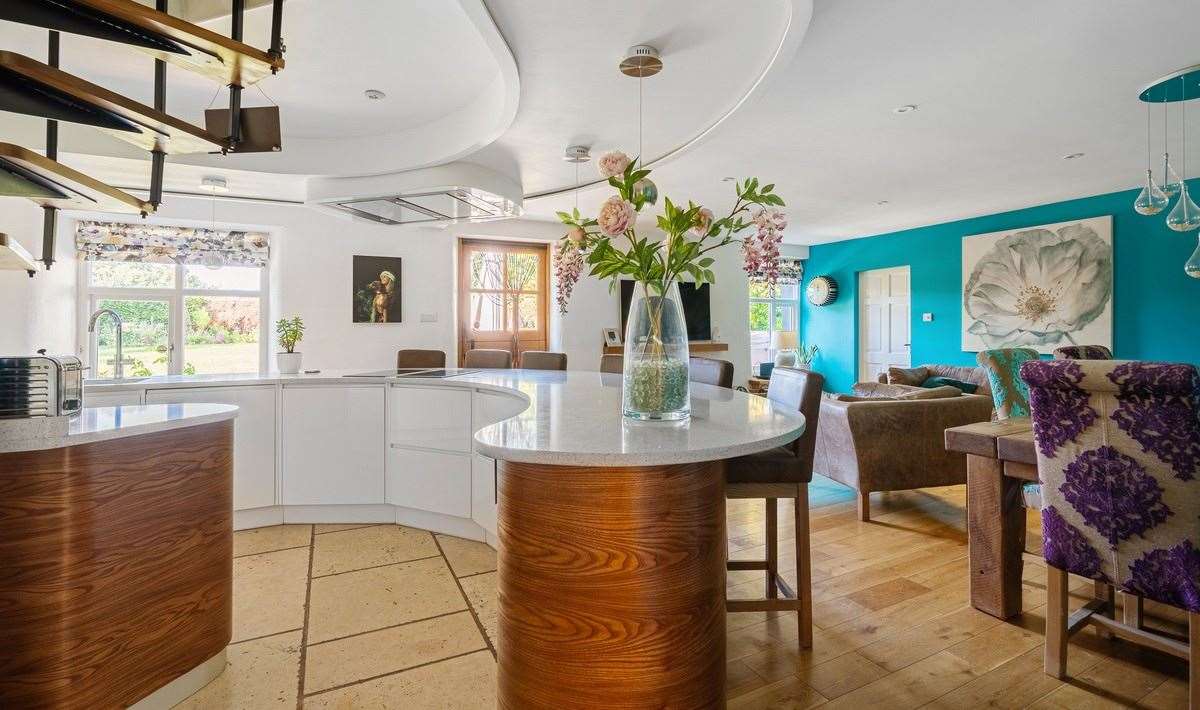 The open-plan kitchen and dining room have an unusual curved shape. Picture: Tyron Ash International