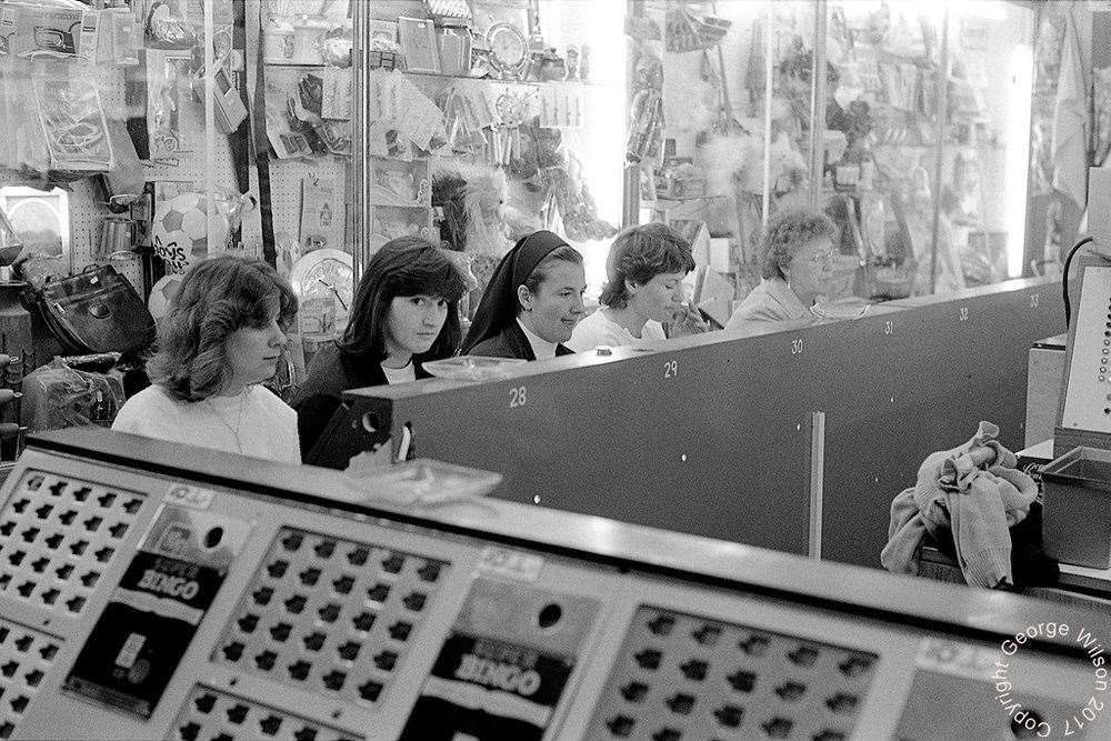 One girl spots George's camera while everyone else was 'eyes down'. Copyright: George Wilson