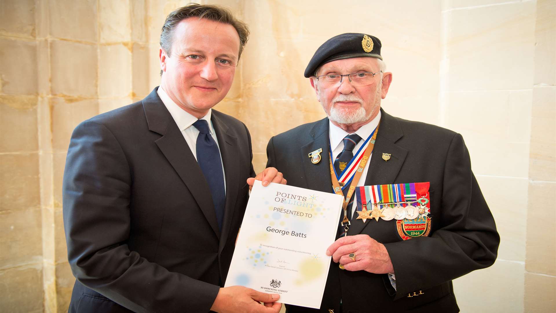 George Batts, pictured receiving a Point of Light award from David Cameron, has been made an MBE