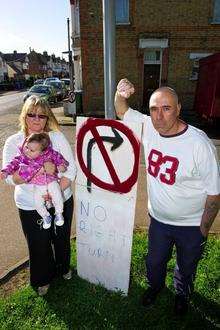 Diane and Dave Askew, with grand-daughter Graycie Vidler, six months, and Dave’s homemade No Right Turn signs