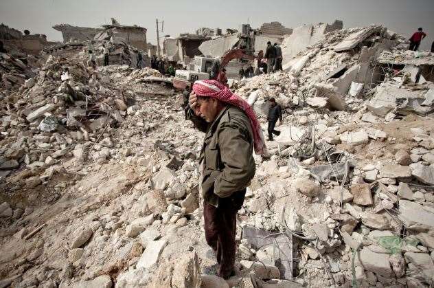A Syrian man stands amid the rubble of his house. Picture: Pablo Tosco/AFP/Getty Images