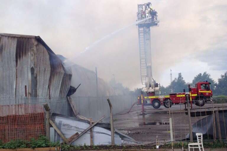 Firefighters tackle the blaze in a collapsed building from above. Picture: @Busa_Bloodbike