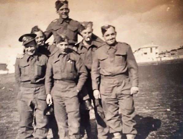 Stan Tebbutt pictured in the middle row on left with fellow troops