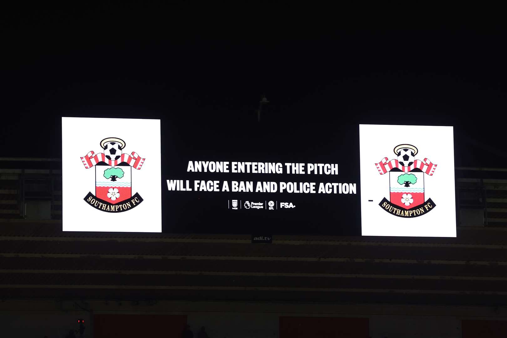 The large stadium screen warning fans to stay in their seats (Steven Paston/PA)