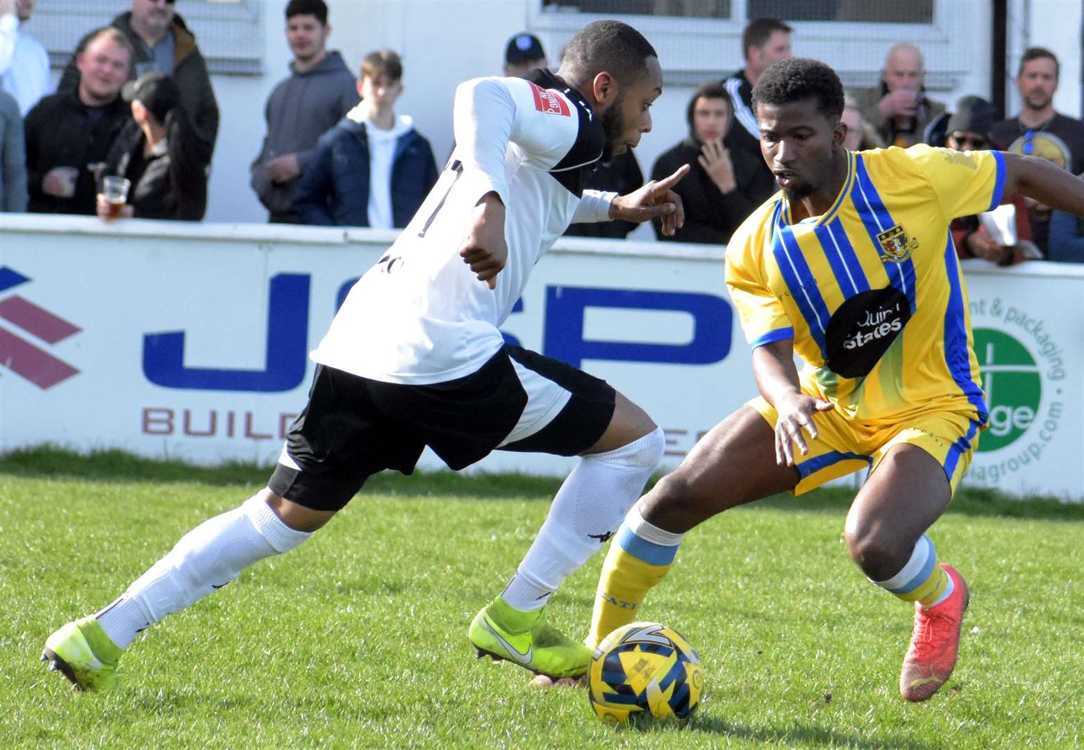 Faversham winger Kieron Campbell runs at Donvieve Jones who faced his old club. Picture: Randolph File