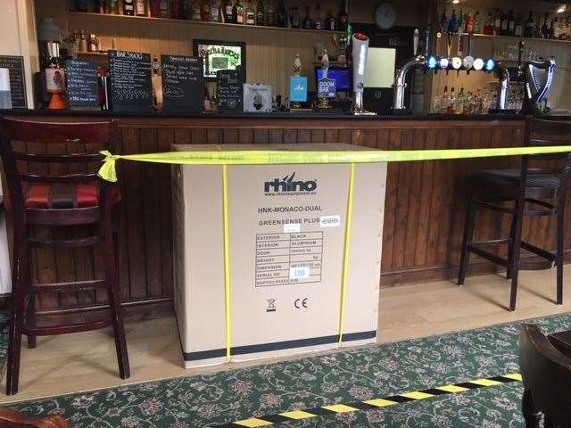 Not needed just yet, this new fridge hasn’t been unpacked, so it’s been brought into service to help keep customers the right distance from the bar