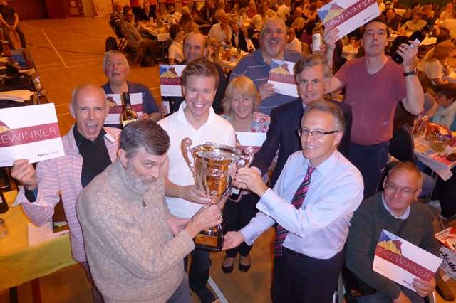 Supernova captain Richard Cribb receives the Ashford Big Charity Quiz 2014 trophy from Richard Rix of Hallet and Co, Clive Perry of Specsavers and Gareth Harmer of PropertyOnline.