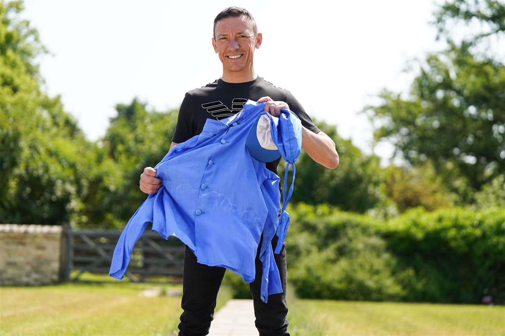 Frankie Dettori holds a set of racing silks at his home in Newmarket, Suffolk (Jacob King/ PA)