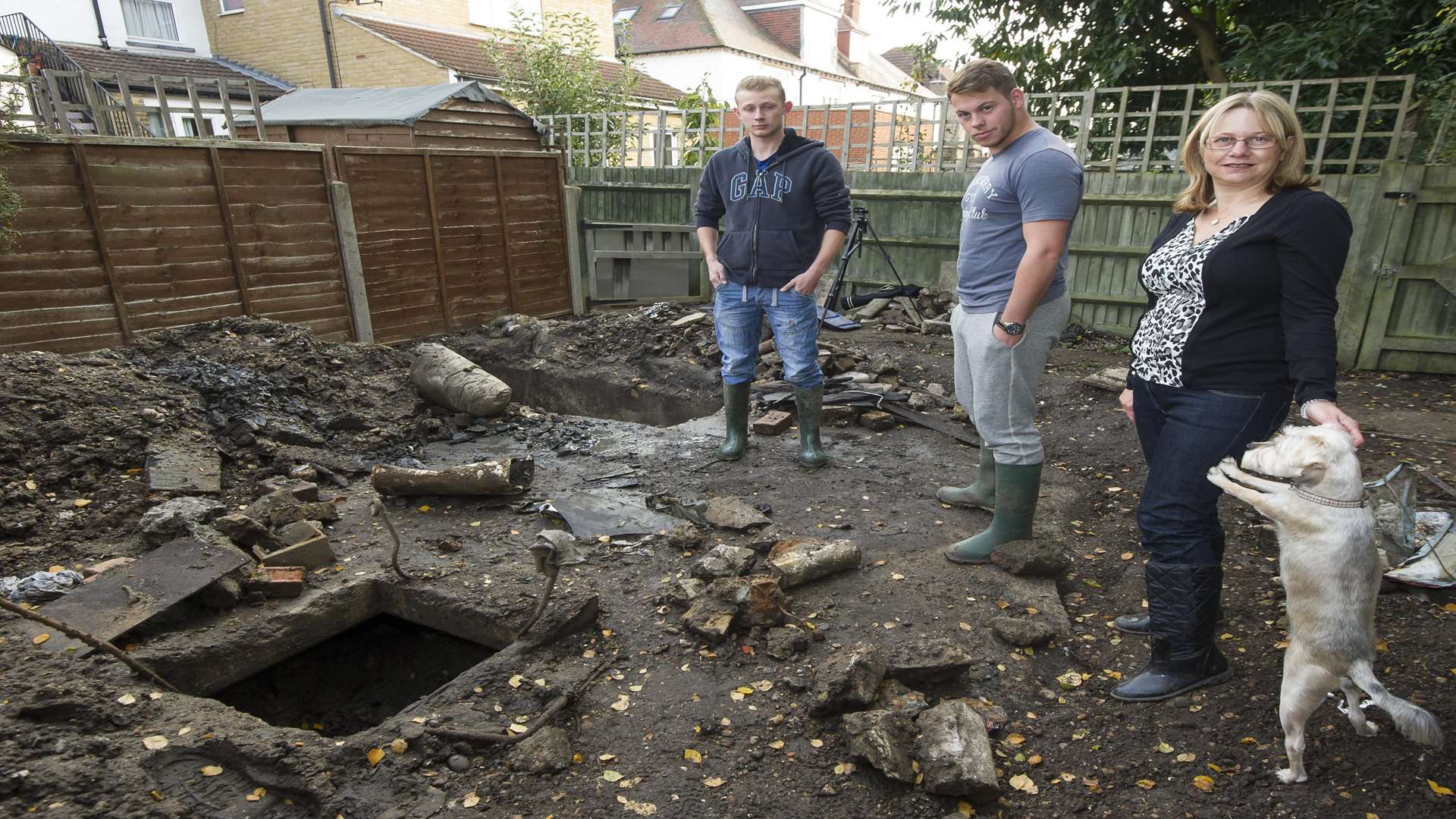 James Dye, Liam Brain and Liz Daniels with the buried air raid shelter. Picture: Andy Payton