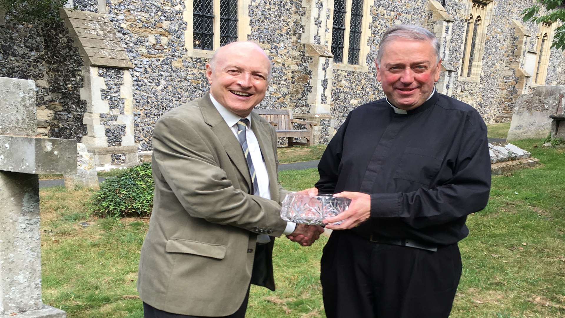 Churchwarden Hugo Jordan presents an engraved bowl to Canon Roberts