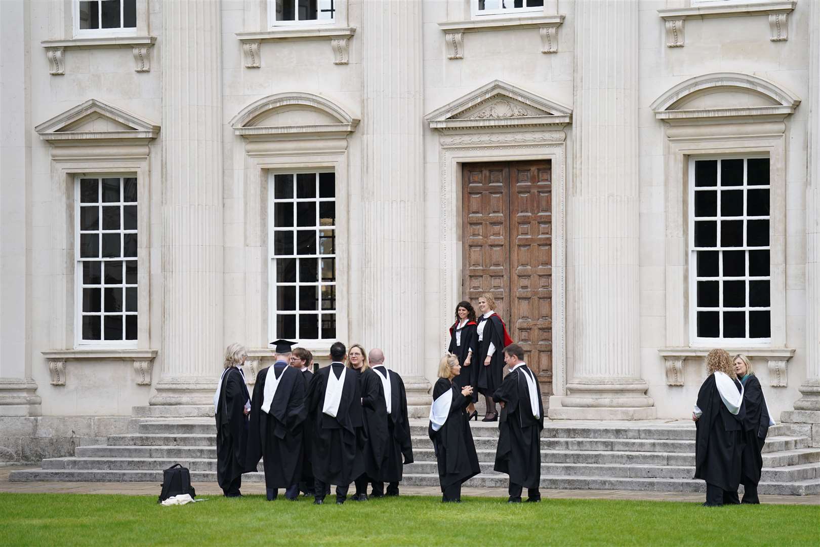 Graduating students take photos outside Senate House at Cambridge University (Joe Giddens/PA)