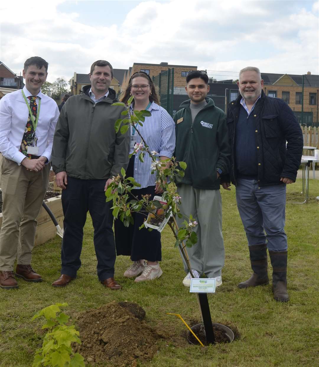 From left: Interim headteacher Joshua Croucher, Mark Pullin (EDC), Katie-Louise Lawrence, Harry Zimmerman (EDC) and Kevin McGeough (EDC) with a tree donated to Ebbsfleet Primary School by Ebbsfleet Development Corporation. Photo credit: Poppy Webster