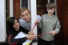 Gerald Bamfield of Saddleton Road, Whitstable, with his sons Alexander,13, and Dan,15, and a collection of elastic bands dropped by the postman