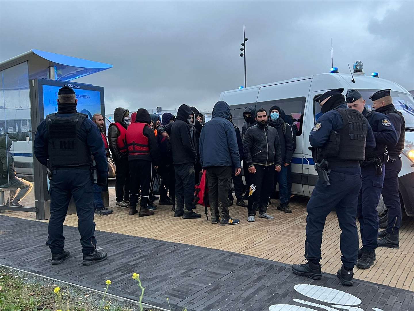 Police detain asylum seekers attempting to cross the Channel on Thursday Picture: UKNIP