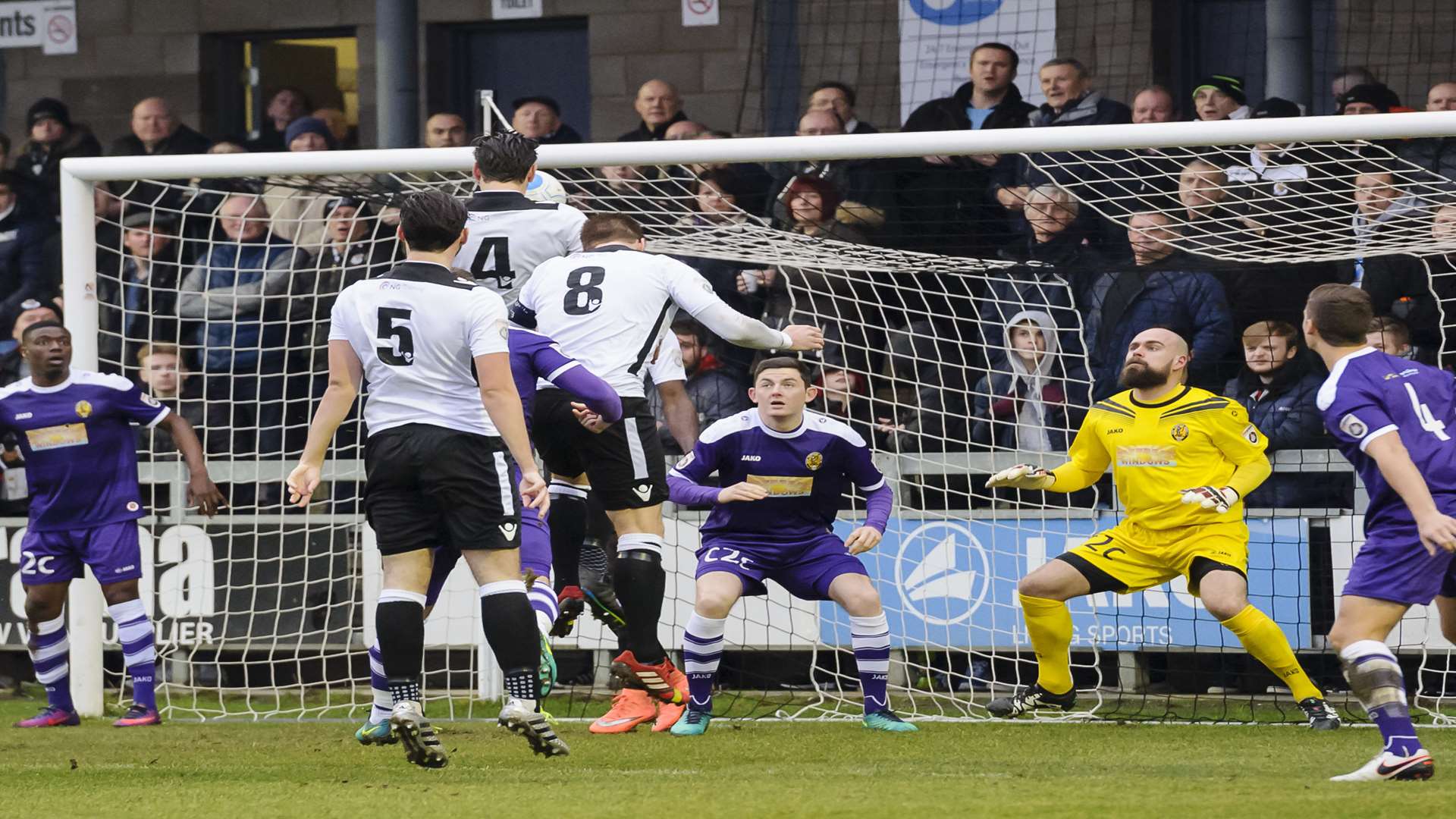 Tom Bonner (4) heads in Dartford's opening goal. Picture: Andy Payton