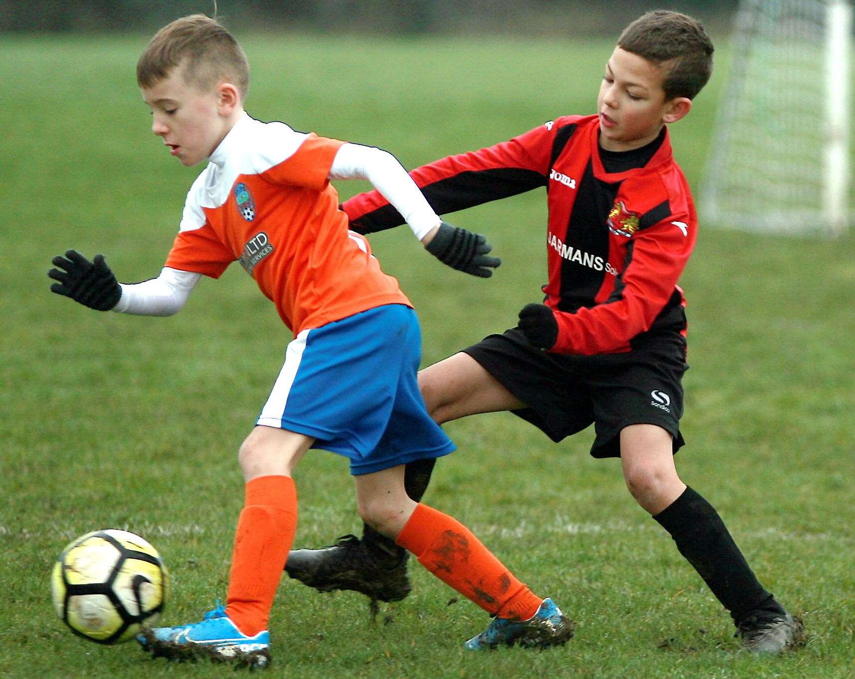 Cuxton 91 Cannons under-8s (orange) on the ball against Woodcoombe Youth under-8s. Picture: Phil Lee FM27663941