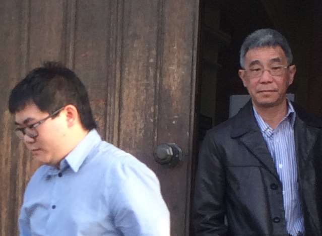 Yuen Ho Ng, 30, (front) leaves court with his father Eric Wai Keung Ng, 60