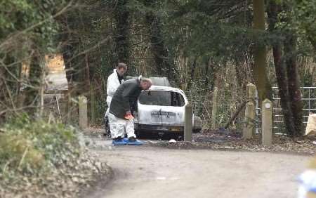 The burnt out car being examined by scenes of crime officers. Picture: GERRY WHITTAKER