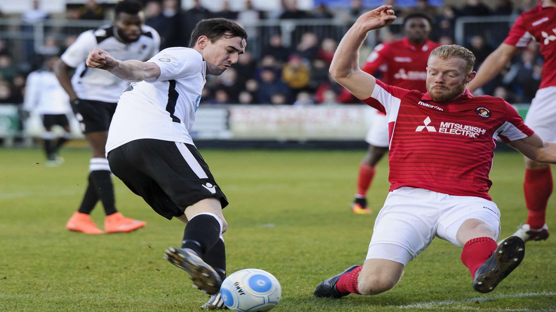 Dartford's Danny Harris on the ball as Fleet's Kenny Clark slides in. Picture: Andy Payton