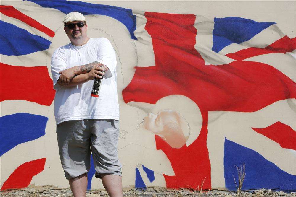 Artist Darren Cullen with his graffiti mural of the royal baby