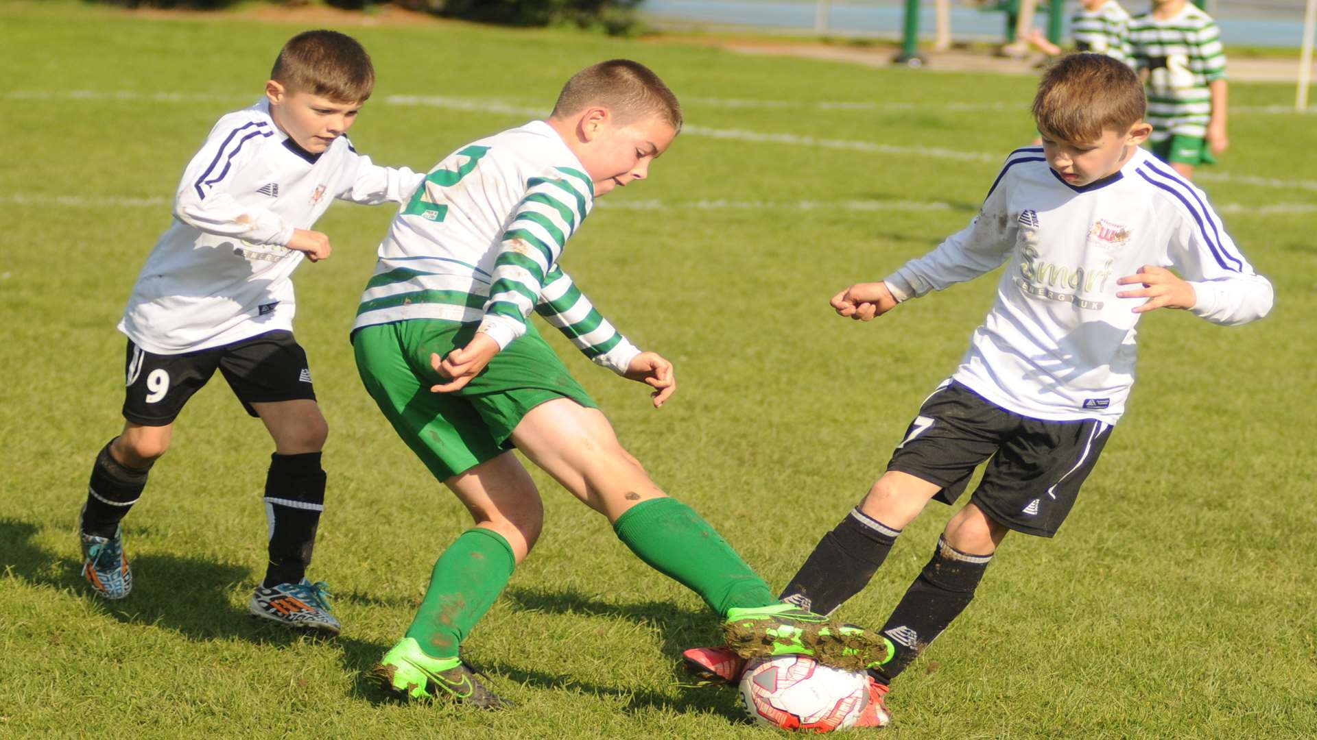 Woodcoombe under-10s, black and white, are two versus one against New Ash Green Picture: Steve Crispe