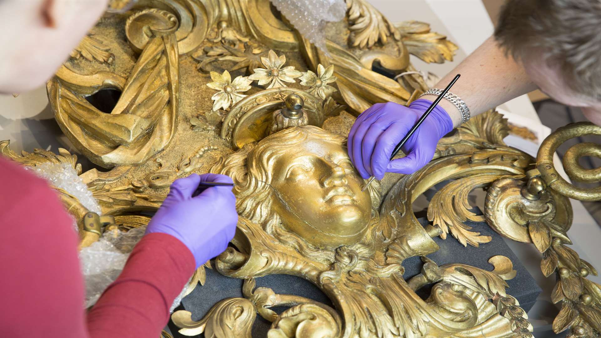 18th century William Kent designed, carved and gilded sconces from the Ballroom at Knole being restored. Picture: National Trust