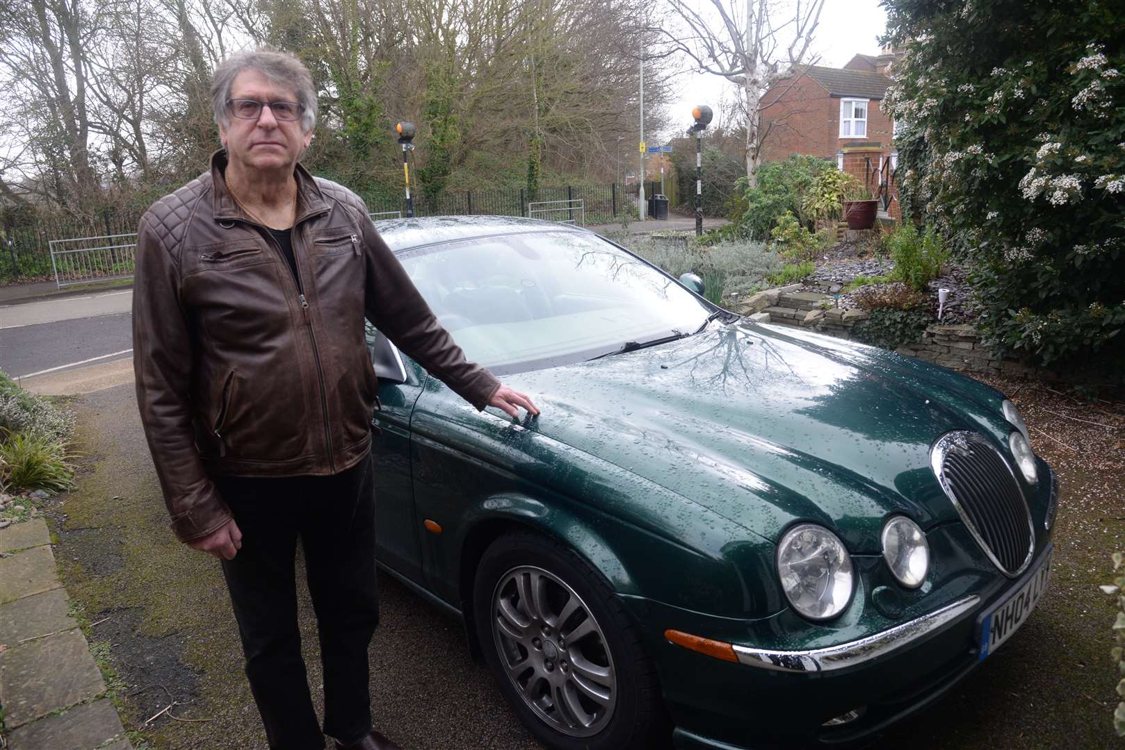 Graham Redman from Canterbury next to his car which hit a boulder thrown from an A2 bridge. Picture: Chris Davey