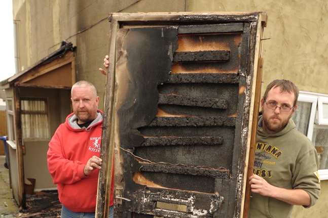 Ian Maggs and James Ellis with the damaged door