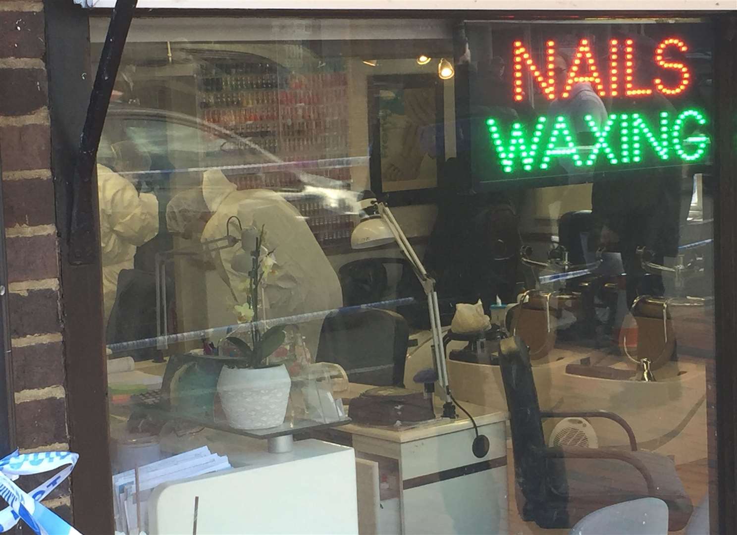 Forensics officers inside the nail bar in Tonbridge High Street following the attempted murder