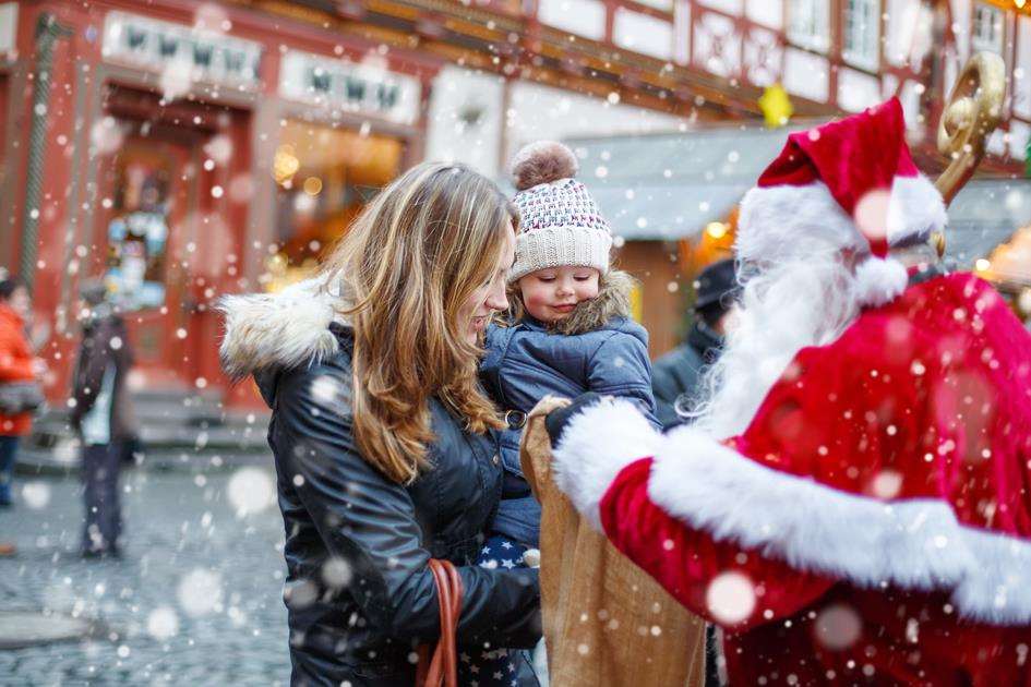 Cute toddler girl with mother on Christmas market. Funny happy kid taking gift from bag of Santa Claus. holidays, christmas, childhood and people concept. Happy family during snowfall on winter day. (5273931)