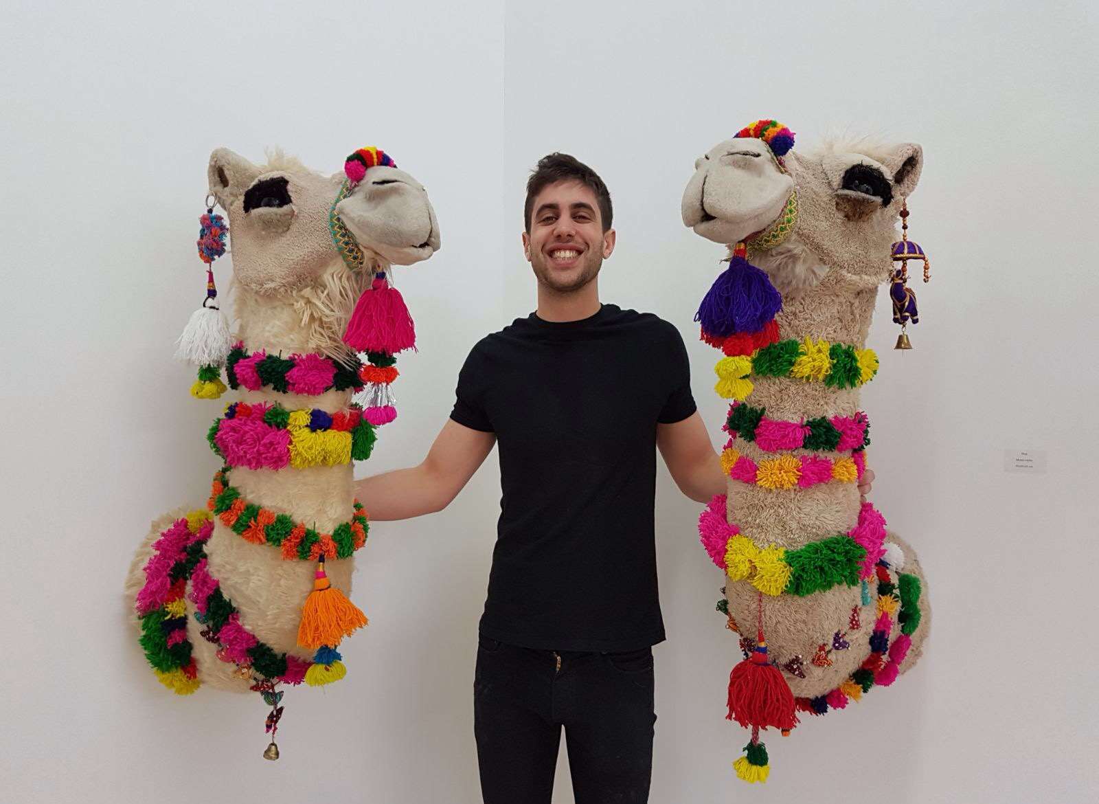 Joshua Gluckstein with his camels which are being exhibited at Kings Hill Control Tower