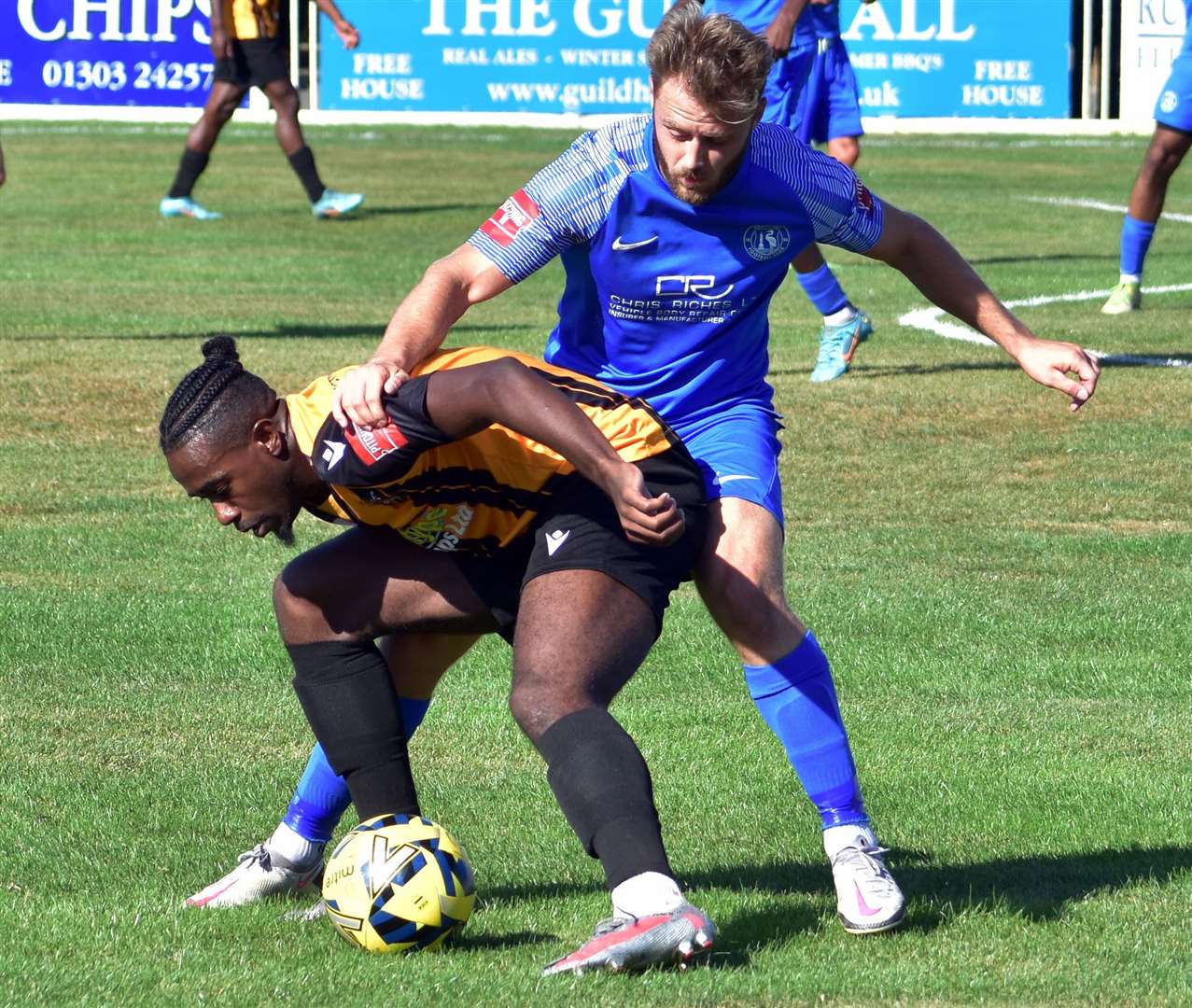 Ira Jackson under pressure for Folkestone against Herne Bay's Jack Parter at Cheriton Road earlier this season. Picture: Randolph File
