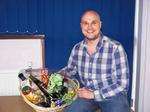 Andy Walker with the raffle prize for the Medway Messenger's curry night