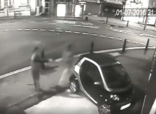 Footage shows a man firing the gun at the car window.