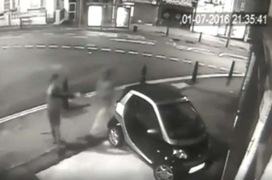 Footage shows a man firing the gun at the car window.