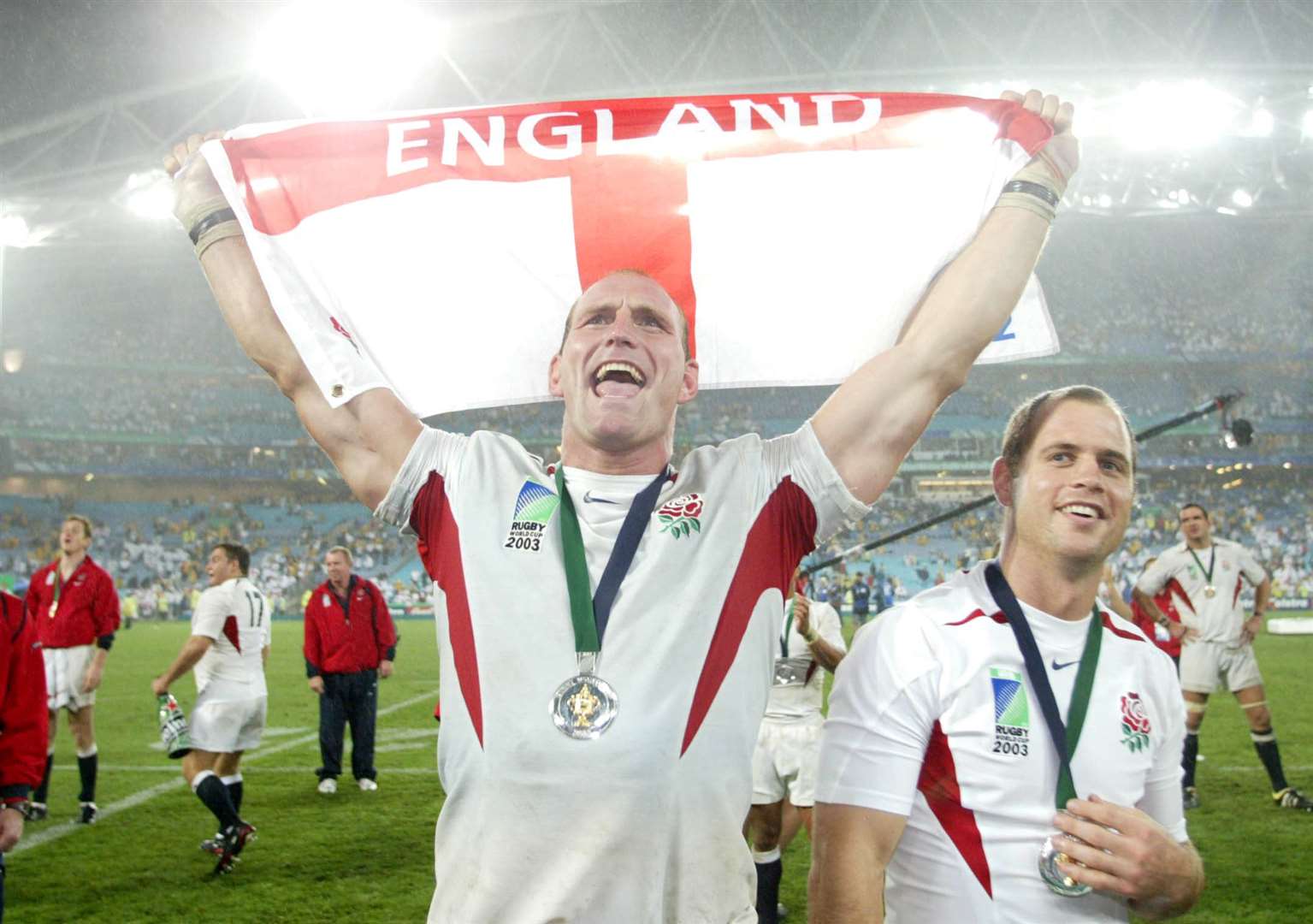 Lawrence Dallaglio, left, and Kyran Bracken celebrate after England’s World Cup win in 2003 (David Davies/PA)