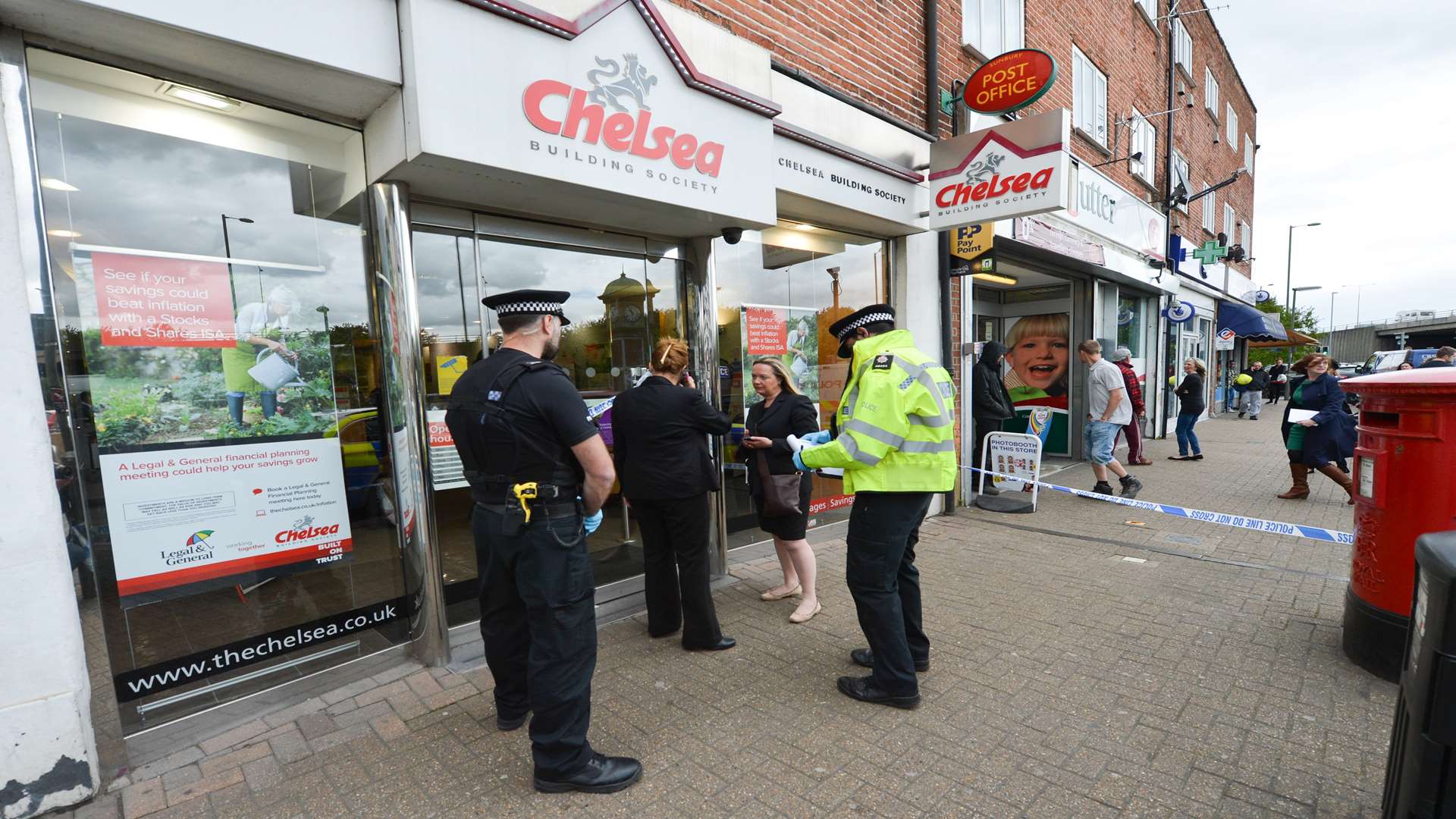 Police outside the Chelsea Building Society in Sunbury after the raid. Picture: SWNS.com/Tony Kershaw