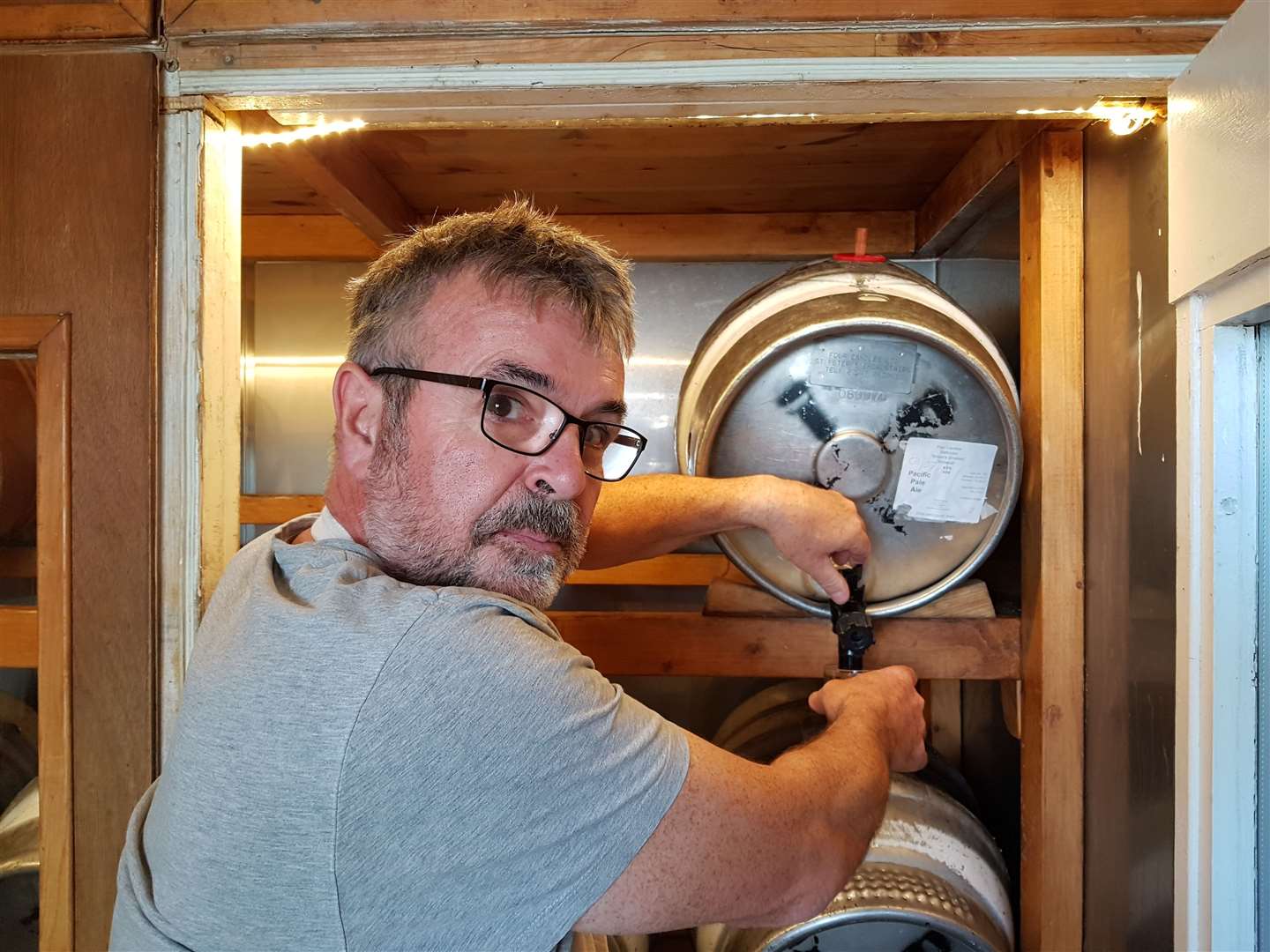 Mike Beaumont taps into one of his brews at the Four Candles brewpub in Broadstairs